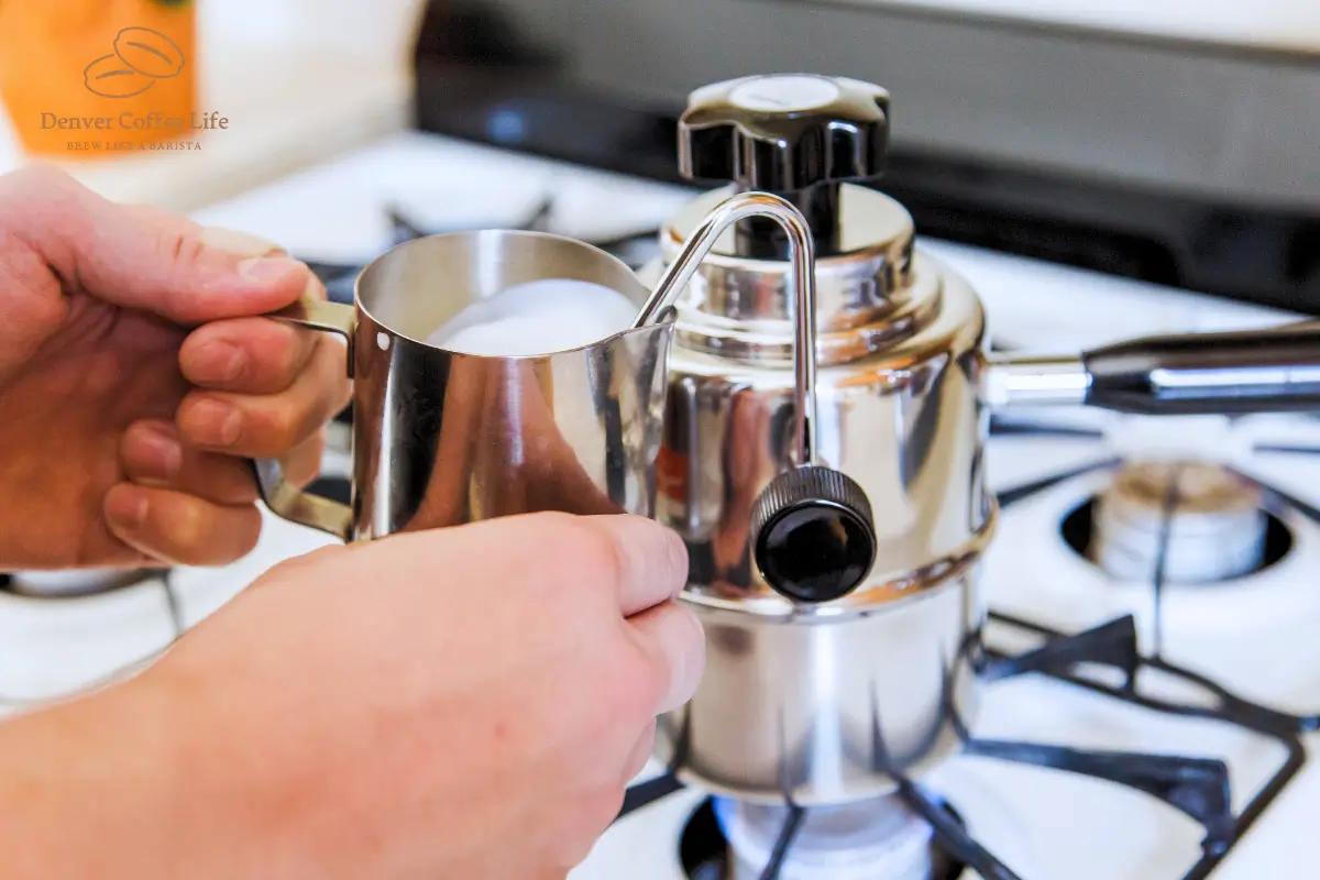 a person pouring milk into a metal container