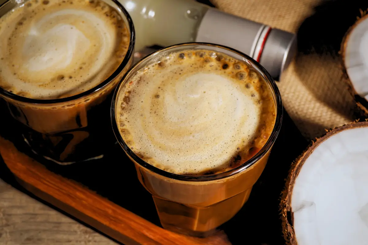 two glasses of coffee with foam on top